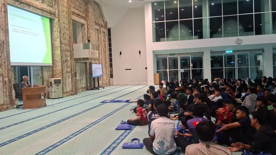 Large community audience attending a facilitation session at Masjid UTP